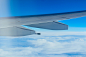 Airplane wing in a blue sky over the clouds by Kazuki Okamoto on 500px