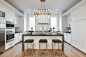 Eat-in kitchen - large contemporary l-shaped light wood floor and brown floor eat-in kitchen idea in Houston with an undermount sink, recessed-panel cabinets, white cabinets, granite countertops, white backsplash, porcelain backsplash, stainless steel app