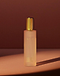 Under a spotlight against a shadowy pink background sits the Brume De Beauté beauty mist packaged in a matte glass bottle with a gold cap.