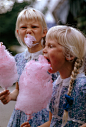 Girls eat large swirls of cotton candy in Copenhagen, Denmark, January 1963.Photograph by Gilbert M. Grosvenor, National Geographic