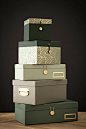A stack of decorative storage boxes in green colours
