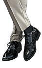 the legs and shoes of a man in white pants, black shoes and gray slacks
