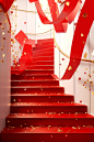 Stair case with red boxes and gold confetti falling down, in the style of monochromatic color scheme, living materials, wrapped, festive atmosphere, associated press photo, lively tableaus, curvilinear forms