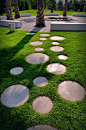 10 Ideas for Stepping Stones in Your Garden // These round stepping stones surrounded by grass, connect the various areas of this Slovenian park, and a touch of fun with their circular shape reminiscent to bubbles or marbles.
