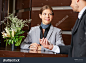 Friendly hotel receptionist and business guest at check-in