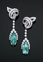 A Pair of Diamond Ear Clips with Emerald Pendants   Each comprising a detachable pear-shaped emerald pendant weigh 11.93 and 8.78 carats with a circular-cut diamond border to the diamond line suspended from the scrolled openwork circular-cut diamond surmo