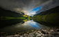 General 1300x833 photography landscape nature lake mountains dark clouds reflection stones summer Norway nordic landscapes