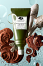 a tube of organic cosmetics surrounded by mushrooms and other things in the water with bubbles around it