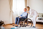 Nurse and senior man in wheelchair during home visit. by Jozef Polc on 500px