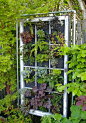 Great Use for A Salvaged Window- A Vertical Garden - make a small wall of them if your neighbor's house is just a little too close for comfort//too visible//an eyesore:
