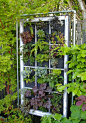 Great Use for A Salvaged Window- A Vertical Garden - make a small wall of them if your neighbor's house is just a little too close for comfort//too visible//an eyesore: 