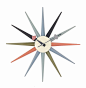 Sunburst Clock - Multicolor : This clock is inspired by classic mid-century modern designs. It has wooden spokes radiating from the central face that serve as hour markers. It has metal hands. It is operated by a single battery, making it easy to install 