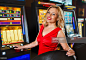 Smiling woman gambling on slot machines in the casino. : Stock Photo