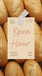 This may contain: a close up of bread rolls with a paper sign on it that says open hour