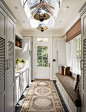 Example of a classic black floor entryway design in New York with beige walls and a white front door