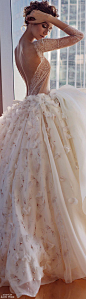 Gorgeous wedding dress with a sheer lace bodice and sleeves and full floral skirt: 