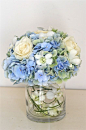Hydrangea centerpiece as one of the three vases on the tables. I like how the other flowers are mixed in with the hydrangea.: 