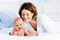 Mother and baby on a white bed Premium Photo