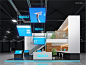 This may contain: an exhibition stand with blue and white signs hanging from the ceiling, in a dark room
