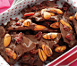 Almond-Cherry Chocolate Bark

3/4 cup whole skin-on almonds
12 ounces dark chocolate (60 percent to 70 percent cocoa)
1/2 teaspoon pure vanilla extract
toasted almonds
1/3 cup dried tart cherries
