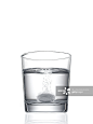 tablet fizzing in glass of water