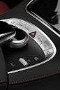 This may contain: an automatic gear lever in the center of a car's dashboard, with buttons and controls