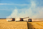 Combines and Tractor Working Together