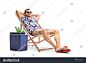 Tourist relaxing in a deck chair next to a cooling box filled with bottles of beer isolated on white background