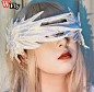 其中可能包括：a woman with long blonde hair wearing white wings on her head and eyeliners