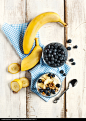 Yogurt with homemade granola, banana and blueberries. - stock photo