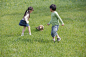 人,衣服,牛仔裤,度假,户外_83666234_Children playing with a cute puppy in park_创意图片_Getty Images China