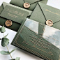 Acrylic invitations with deep green envelopes and golden sealing wax.