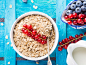 Oats in a bowl with berries on bright blue textured background by Sofya Bolotina on 500px