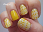 yellow manicure stamped with white