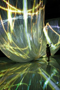 Fall in Pop (mintdesigns, Nobuhiro Shimura) at Milano Salone 2012: Canon Neoreal – In The Forest. -- "A screen structure created by pleated cloth folded in multiple overlapping layers, on which a cascade of colors are projected to create a vibrant, c