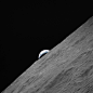 Cresent Earth rises above lunar horizon