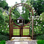 What a pretty scene with a arbour and gateway entrance to the garden .. even a lovely gazebo in the garden