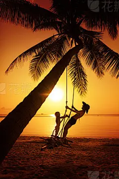 Family sitting at tropical swing
