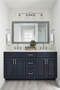 Mid-sized transitional 3/4 light wood floor and gray floor bathroom photo in Other with recessed-panel cabinets, black cabinets, white walls, an undermount sink and gray countertops