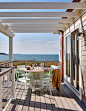 Inspiration for a mid-sized coastal side yard ground level cable railing deck remodel in Boston with a pergola