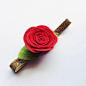 This is a felt red rose headband. The rose is attached to a shiny gold FOE headband.: