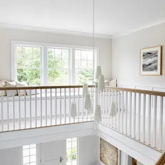 Inspiration for a large timeless light wood floor and brown floor entryway remodel in New York with white walls