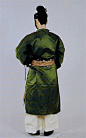 日本时代衣装演变 （四） : 17.奈良时代武官的朝服 
    人偶身着养老2年衣服令规定的六位武官的朝服。冠帽为皀缦头巾和柔软的黑绢制成。冠帽在下颌处系上纽带，缨（帽子的纽带）弯曲起来。身着深绿色相当于六位的阙腋，悬挂黑漆的横刀，手持木笏，脚穿白色袜子，着乌皮鞋。  
        六位以下的武官对于礼服没有规定，在重要的仪式场合，一般身穿裲襠，系上红色的护胫穿纤维编织的鞋子，携带弓箭。 
    所谓武官，在当时主要是从事类似于现在的军队、警察和法院的工作，并非我国常见的理解。 