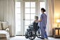 Nurse and older patient in wheelchair standing near window by Gable Denims on 500px