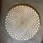 This may contain: a wooden plate with an intricate design on it