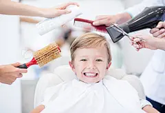 Boy at the hairdressing salonBoy at the hairdressing salon getting a haircut and looking very happy