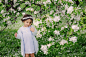cute dreamy toddler child girl walking in blooming spring garden, celebrating easter outdoor by Мария Евсеева on 500px