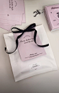 there is a bag with a ribbon on it next to some cards and other items