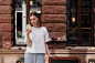 Picture of attractive woman holding phone in white tshirt