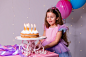 cute-little-girl-beautiful-dress-makes-wish-blows-out-candles-birthday-cake (1)